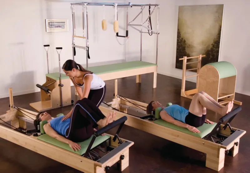 An instructor guiding a Reformer Pilates session at ZEN ME in Athens