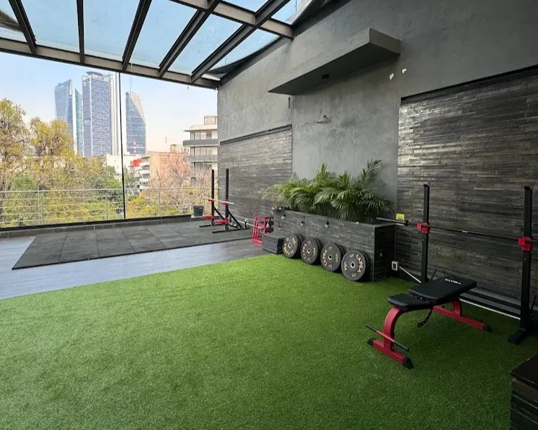 The open-air rooftop training space at Daava in Condesa, with the Mexico City skyline behind